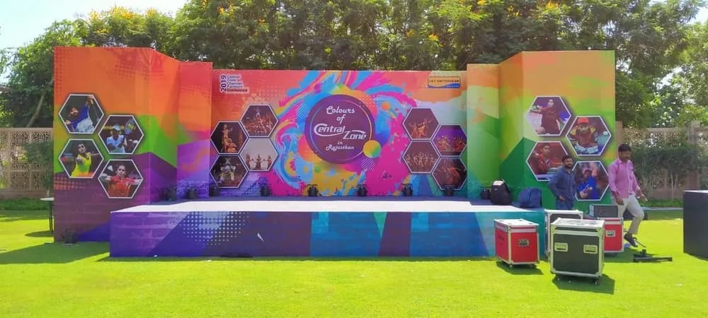 Outdoor event stage with printed backdrop panels, promotional branding by iMad, Jaipur