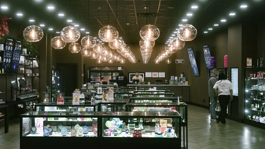 Retail store interior with glass display counters and pendant lights