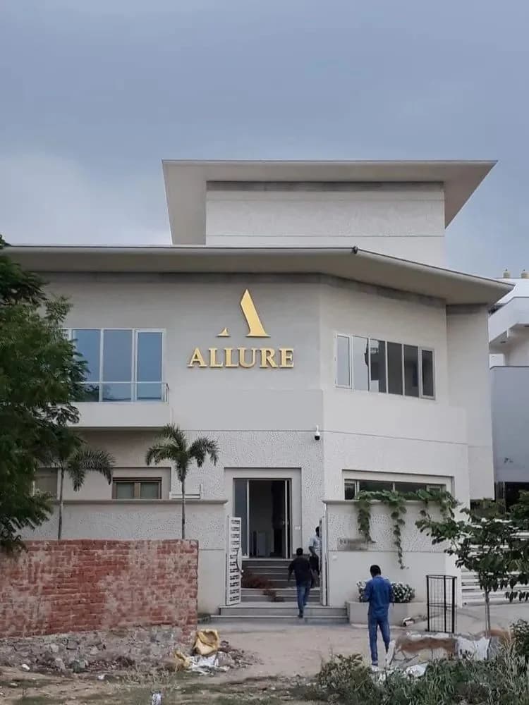 Lettering mounted on the facade of a white building, signage work by iMad, Jaipur