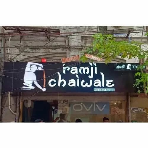Black shop sign board with illuminated lettering, signage work by iMad, Jaipur