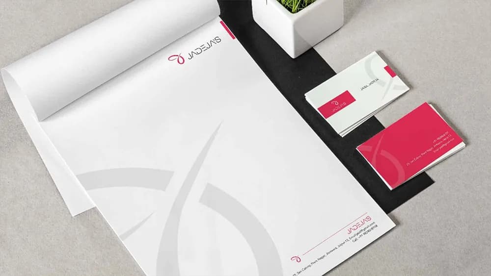 Letterhead and pink and white business cards carrying a Jadeja logo, logo design concept by iMad